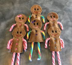 four gingerbread man made out of candy canes