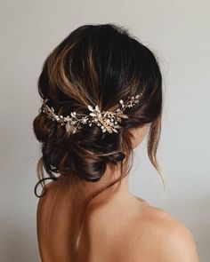 the back of a woman's head wearing a bridal hair piece