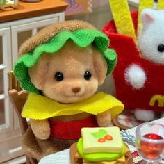 two stuffed animals are sitting at a table