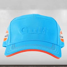 a blue hat with an orange brimmed peak and the word columbia on it