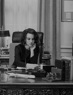 a woman sitting at a desk in an office