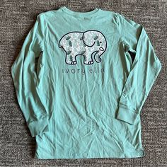 Ivory Ella Brand Women’s Long Sleeve Tshirt Teal With Traditional Elephant Decal And Front Pocket Size Small New With Tags Smoke Free Home Traditional Elephant, Ivory Ella Shirts, Elephant Decal, Christmas Wants, Light Blue Long Sleeve, Elephant Shirt, Ivory Ella, Top Shirt Women, Cute Outfit Ideas