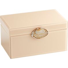 a white box with a shell on the lid