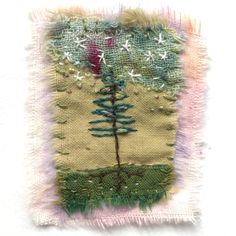 a piece of fabric with a small tree on the bottom and stars in the middle