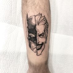 a man's leg with a tattoo of a joker and his face on it