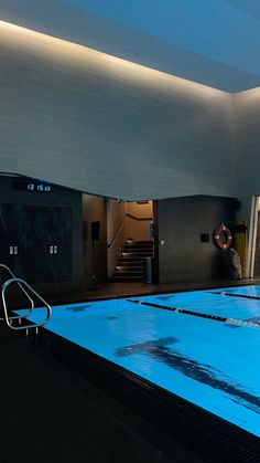 an indoor swimming pool with stairs leading up to the ceiling and water running down it