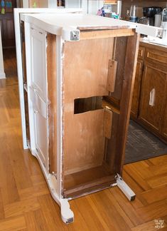 an unfinished kitchen cabinet in the process of being remodeled with wood flooring and white paint