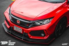 the front end of a red honda civic