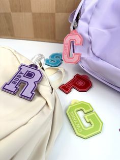 Our personalized bag tags are perfect for backpacks, lunch bags, sports bags, luggage tag, or even as an oversized keychain. Choose from solid colors with white background, our adorable color combinations, or color gradients. We can also print a name on the tag, or leave it blank.  Our tags are guaranteed to last under the harshest conditions for a minimum of six months. If your child manages to break it in that time, just send us a photo of the damage and we will send you a new one right away (just pay $5 postage).  Each bag tag comes with a durable silicon loop to easily attach to your bag. Each letter is 2.5 inches high (total height is 2.9, including the eyelet), but the width of the letter will vary depending on the letter you choose (W will be much wider than the letter I, for exampl Teacher Keychain, Personalized Bag Tags, Color Gradients, Keychain Backpack, Initial Keychain, Letter Bag, Sports Bags, Varsity Letter, Name Patches