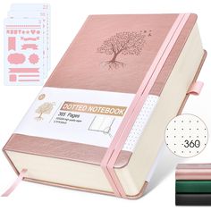 a pink notebook with the cover pulled down and some other items to be used in it