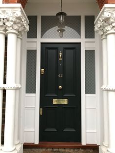 a black front door with two white pillars