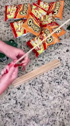 someone is using chopsticks to cut up some candy bars on a counter top