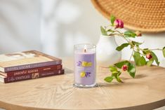 a candle sitting on top of a table next to books