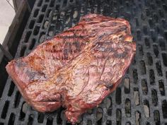 a piece of steak is cooking on the grill