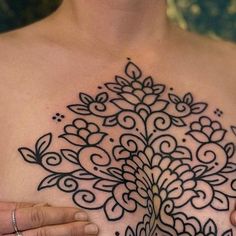 a woman's chest with an intricate design on it