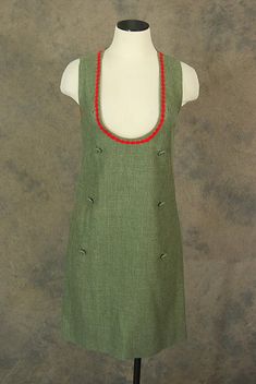 60s wool jumper style shift dress. Olive wool with red trim around the neckline. Deep exagerated scoop neck that is meant to be worn with a blouse underneath. Decorative buttons down the front. A line shape. Sleeveless. Partially lined. Back metal zipper closure.Garment measurements were taken with the garment laid flat and doubled to reach the actual measurement. When comparing a garment's measurement to your own, please allow 1-2 inches for breathing room and proper fit. Size on tag: No size o Sewing Overalls, Jumper Style, 1960s Mod, Wool Jumper, Green Wool, Vintage 60s, Jumper Dress, Shift Dress, 1960s