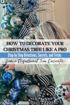 a woman decorating a christmas tree with blue and silver ornaments on it, text reads how to decorate your christmas tree like a pro