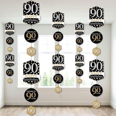 a room filled with lots of black and gold birthday decorations in front of a window