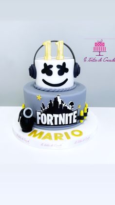 a cake with headphones on top of it that says fortnite hero mario