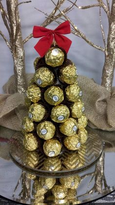 a christmas tree made out of chocolates on a glass plate with burlocks