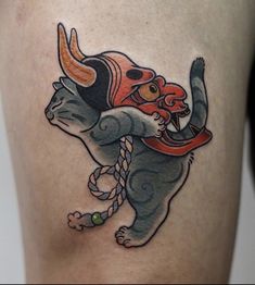 a tattoo on the leg of a person with a bull and rope around his neck