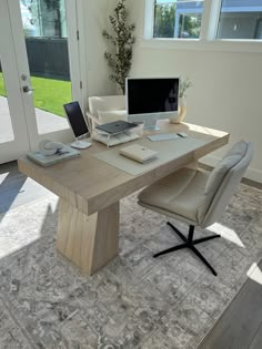 a computer desk with a laptop on top of it