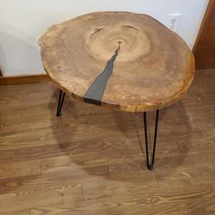 a wooden table with black hairpin legs and a tree stump design on the top