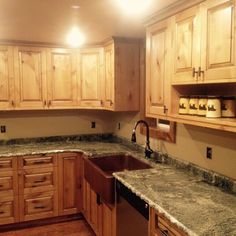 a kitchen with wooden cabinets and granite counter tops