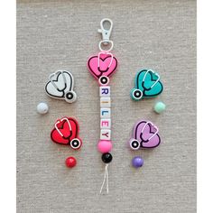 the keychain is decorated with colorful medical items and beads on it's side