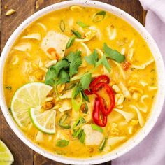 a white bowl filled with chicken tortilla soup and garnished with cilantro