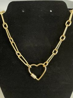 This gorgeous simple necklace is perfect for everyday use or just when you need a little sparkle with your next outfit.  Necklace is 16 inches in length and features a heart shaped carabiner screw charm with micro pave cubic zirconia stones.   Necklace is 14kt gold plated Heart carabiner is 18kt gold plated  How to care for your necklace: - Remove when sleeping  - Do not clean with chemical jewelry cleaner - Gently polish with lint free cloth.  Do not use metal polishing cloth - Store your neckl Trendy Gold Paperclip Necklace, Chic Gold Chain Paperclip Bracelet As Gift, Trendy Everyday Chain Necklace With Heart Charm, Trendy Chain Necklace With Heart Charm For Everyday, Trendy Paperclip Necklace With Lobster Clasp, Trendy Heart-shaped Chain Necklace With Lobster Clasp, Trendy Heart Charm Chain Necklace As Gift, Trendy Chain Necklace With Heart Charm As Gift, Trendy Heart-shaped Everyday Chain Necklace