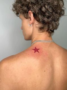 a woman with a red star tattoo on her back