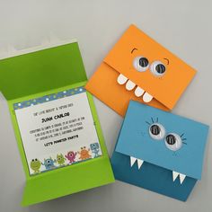 two paper monsters are sitting next to each other