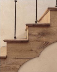 a wooden stair case with metal handrails