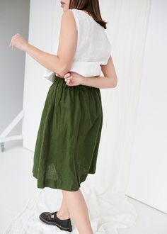 "SIZING & FIT This skirt is loose. Before placing an order, check the approximate measurements of the finished garment given below. Model is 5′6″ (170cm) tall with an 80cm/31″ bust, 68cm/26″ waist, 91cm/35″ hip, and she is wearing an XS in forest green. XS Length ± 65cm | 25.6\" Unstretched waist ± 60cm | 23.6\" Hips ± 130cm | 51.2\" Hem width ± 160cm | 63\" S-M Length ± 65cm | 25.6\" Unstretched waist ± 68cm | 26.8\" Hips ± 138cm | 54.3\" Hem width ± 168cm | 66.1\" L-XL Length ± 65cm | 25.6 Linen Pleated Skirt Bottoms, Linen Pleated Skirted Bottoms, Knee-length Linen Gathered Skirt, Green Linen Lined Skirt, Green Linen Skirt For Summer, Summer Linen Green Skirt, Summer Green Linen Skirt, Casual Green Linen Skirt, Linen Pleated Skirt