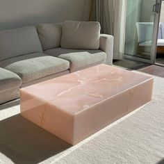 a living room with a couch, coffee table and sliding glass doors