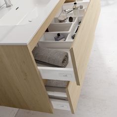 an open drawer in a bathroom sink next to a mirror