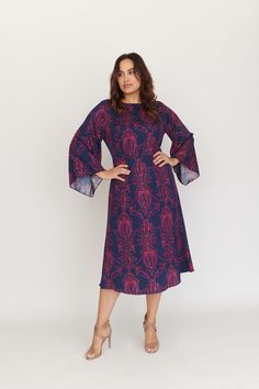 The Lucrezia Bell Sleeve Dress is as diverse as it is chic and works as well before 9 as it does after 5. Take a look at the flattering hourglass fit that truly nips the waist, and the forgiving bell sleeves that waterfall from the shoulders. If you prefer a figure-skimming look, Lucrezia has you covered. The enchanting print in shades of blueberry and blush on our silk twill call to mind sultry nights and delightful days. Let the compliments commence. Product info: 100% Silk Twill. Our model is Party Midi Dress With Blouson Sleeves, Fall Cocktail Dress With Elastic Sleeves, Fitted Midi Dress With Blouson Sleeves, Chic Bell Sleeve Workwear Dress, Elegant Blue Dress With Elastic Sleeves, Fitted A-line Midi Dress With Draped Sleeves, Elegant Bell Sleeve Dresses For Fall, Evening Dress With Blouson Sleeves, Midi Length, Formal Midi Dress With Bell Sleeves For Fall