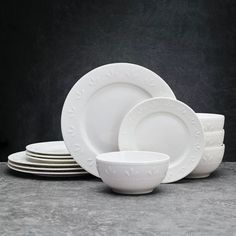 white dishes stacked on top of each other in front of a black background with copy space