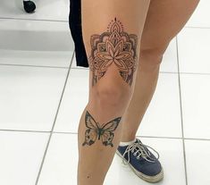 a woman's leg with a butterfly tattoo on her left calf and the bottom part of her leg