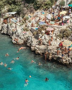 many people are swimming in the blue water