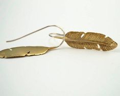 Feather Drop Earrings - Detailed Medium Artisan Feathers in Solid Brass with Sterling Ear-Wire.2 inch drop.Feather measures 1.5 in. long x 0.5 in. wide. STERLING SILVER VERSIONThese gold-tone feather dangle earrings have a sweet boho style. They are lightweight, easy to wear, and stay securely on the ear. For all standard size piercings. Lovely detailed brass feathers hang from Solid Sterling Silver ear-wires. Nickel-free. Hypoallergenic. Adjustable Gold Feather Earrings, Gold Feather Earrings As A Gift, Gold Feather Earrings For Gift, Mother Of Pearl Earrings, Silver Feather, Pearl Flower, Feather Earrings, Ear Wire, Flower Earrings