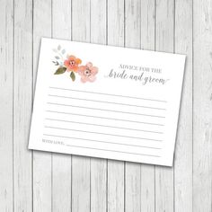 the advice for the bride and groom card with pink flowers on white wood planks