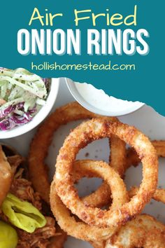 a plate with onion rings and coleslaw on it