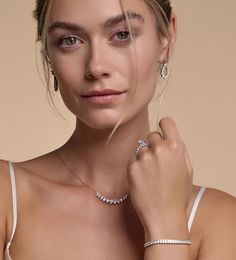 a woman wearing a diamond necklace and bracelet