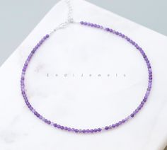 The choker features small, round amethyst beads with a diameter of 3mm. The petite size of the beads contributes to the delicacy and daintiness of the choker, creating a subtle yet eye-catching accessory. Amethyst is a purple variety of quartz, known for its captivating violet hues. Amethyst is the birthstone for the month of February, and wearing a choker with amethyst beads can carry personal significance for those born in that month.  The smaller bead size and simple beaded design contribute Violet Crystal, Purple Quartz, Chain Extenders, Amethyst Beads, Nature Bracelets, Beaded Choker, Handmade Necklace, Jewelry Pouch, Petite Size