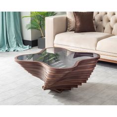 a coffee table that has been designed to look like a wave on the glass top