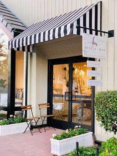 a store front with black and white striped awning