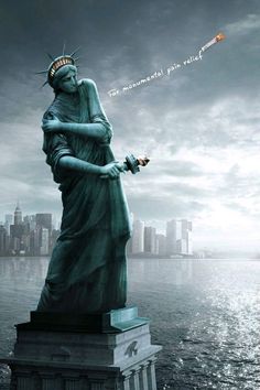 the statue of liberty is in front of a cityscape with an inscription on it