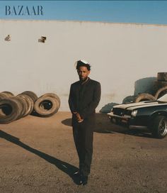 a man standing in front of some old tires